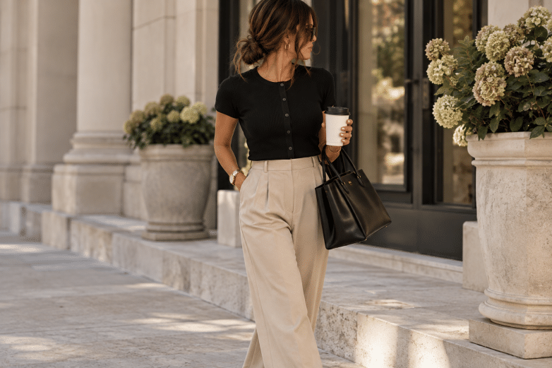 Fall work outfits: black button tee, beige wide-leg trousers and a black tote